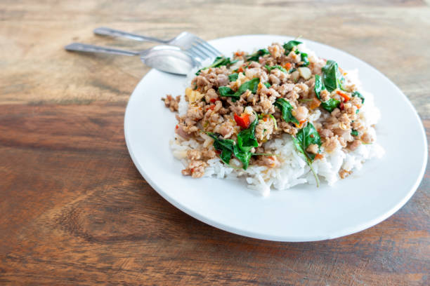 istock Rice topped with stir-fried pork and basil in a white dish. 1206934183