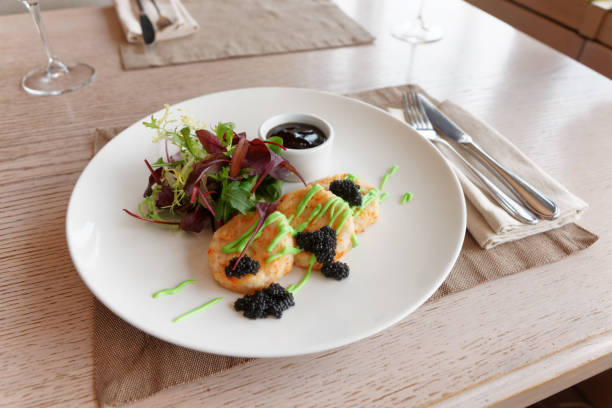 istock Crab cakes with salad mix 1206934465