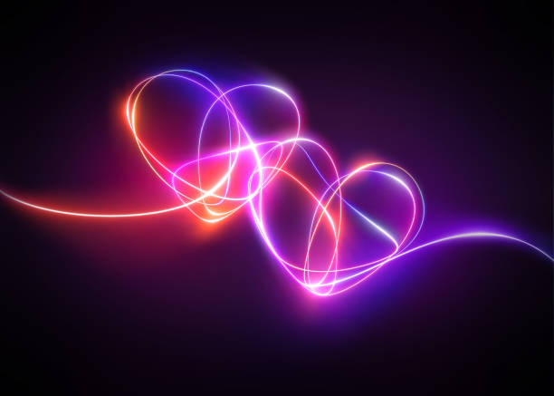 istock pink red neon light drawing, hearts linked together. Abstract doodles isolated on black background. Glowing single line art. Modern minimal concept. Festive illustration for Valentine day. Copy space 1206934927