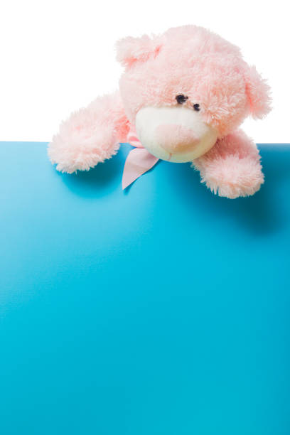 istock Cute teddy bear pink on color background with copy space 1206936312