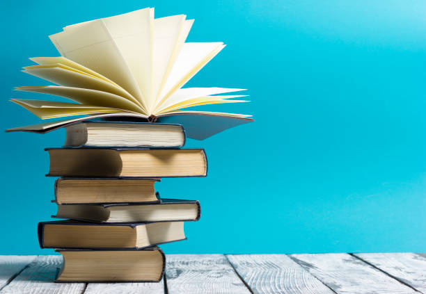 Open book, hardback books on wooden table. Back to school. Copy space.