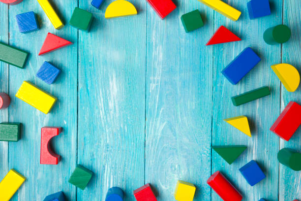 Kids educational developing toys frame on white background. Top view. Flat lay. Copy space for text