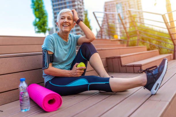 istock Active senior woman eating apple after exercise 1206937478