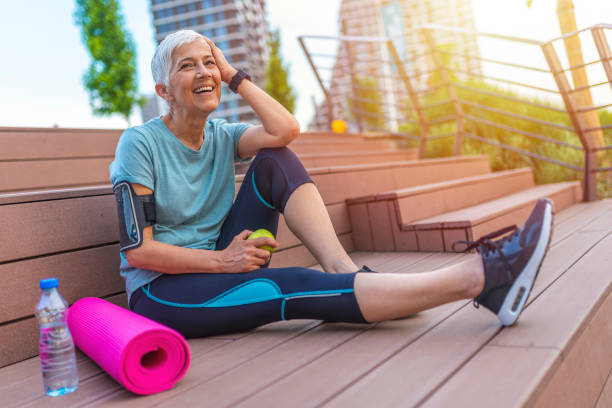 istock Senior woman with apple and water. 1206937589