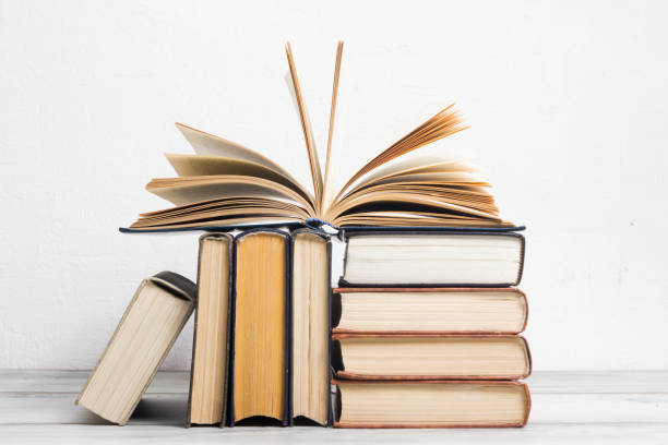 istock Open book, hardback books on wooden table. Back to school. Copy space. 1206937597