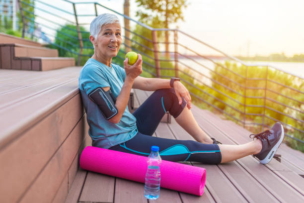 istock Active senior woman eating apple after exercise 1206937623