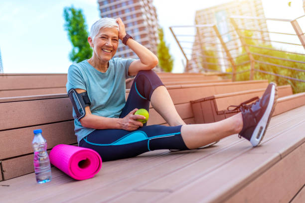 istock Senior woman with apple and water. 1206937653