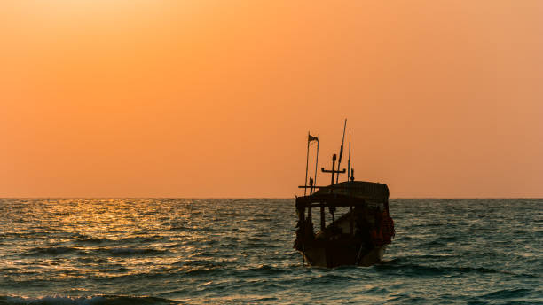 istock Sunrise, ocean and a boat on Koh Rong 1206937681