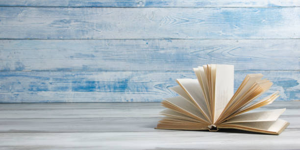 istock Open book, hardback books on wooden table. Back to school. Copy space. 1206937953