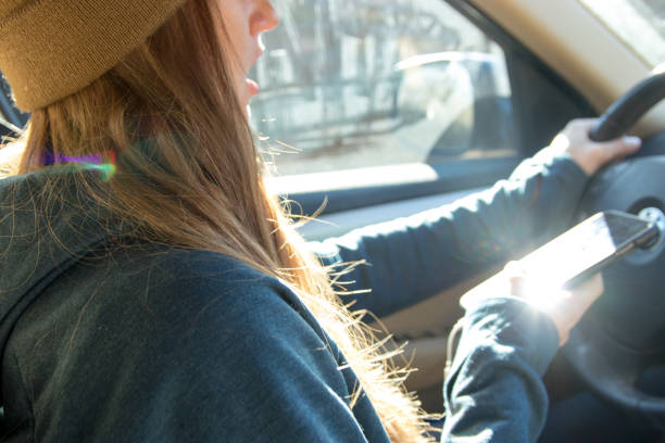 istock Woman texting and driving 1206944070
