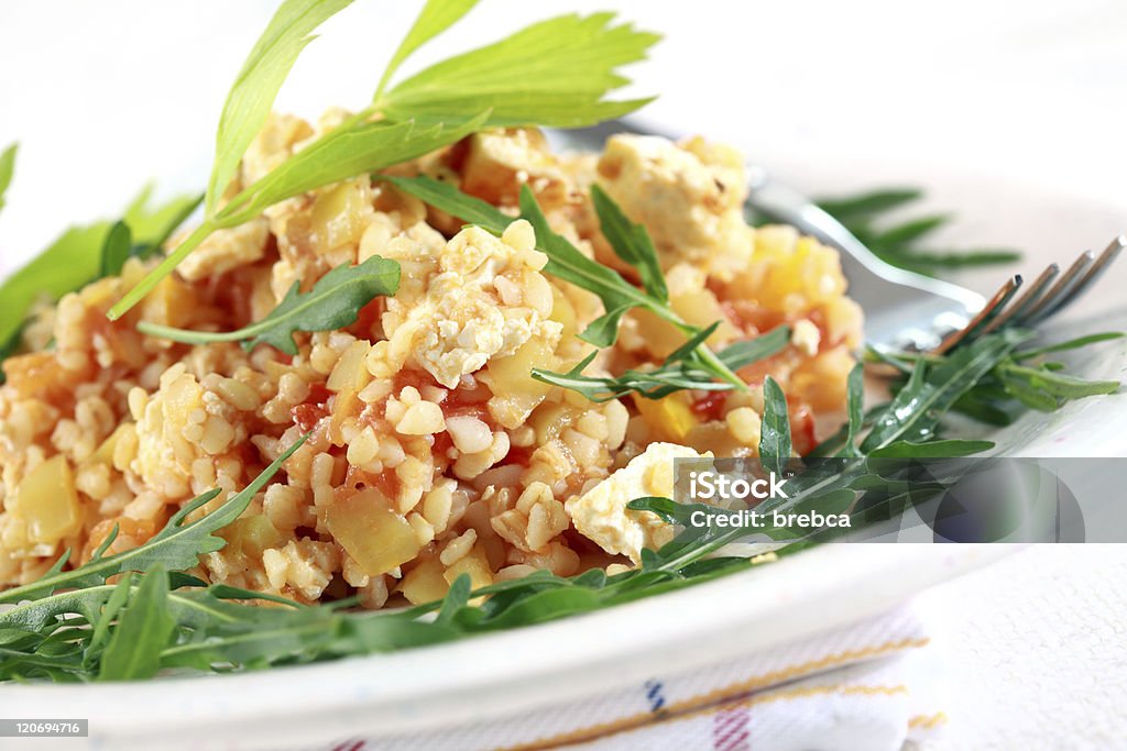 Risotto with bulgur Bulgur risotto with arugula saladBulgur risotto with arugula salad Arugula Stock Photo