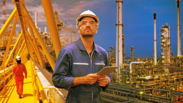 istock engineer staff worker with tablet in hand and refinery background concept. 1206949338