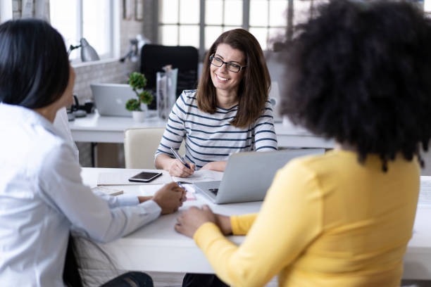istock Coworkers sitting in office and talking 1206955060
