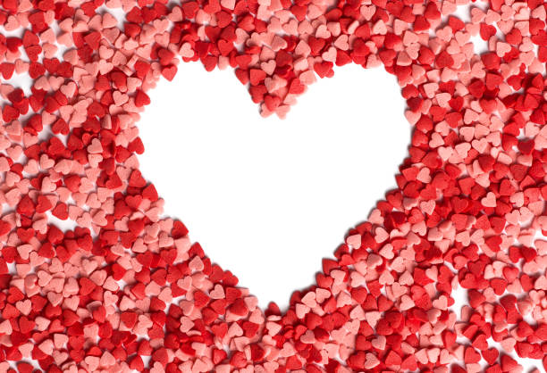 istock Heart shaped made from sprinkles. Heart shape with empty space for text in the centre of heart top view. Valentines Day background. 1206955721