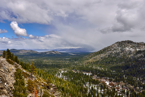 South Lake Tahoe as viewed from Echo Summit on the Lincoln Highway.  The South Lake Tahoe airport can be seen in the distance in the center of the frame and the casinos are directly under the horseshoe shaped weather cloud to the right.