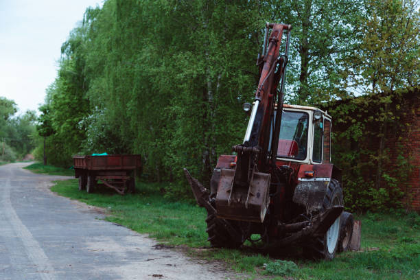 istock red old rusty tractor in a field near road 1206964896