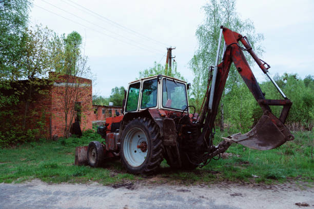 istock red old rusty tractor in a field near road 1206964912