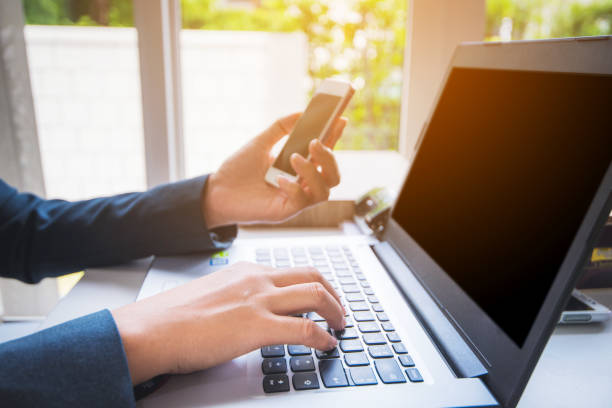 istock Businessman working with laptop and smart phone at office 1206968257