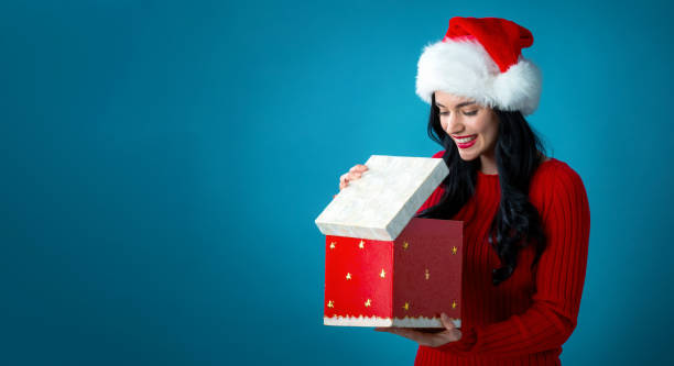 istock Young woman opening a Christmas gift box 1206970310