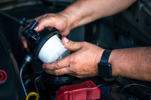 Fuel filter Car mechanic replace the new fuel filter at modern diesel engine. car service or preventive maintenance. filtration stock pictures, royalty-free photos & images