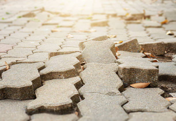 The floor of the footpath is broken. the footpath is uneven.May cause people to stumble and fall. The floor of the footpath is broken. the footpath is uneven.May cause people to stumble and fall. uneven stock pictures, royalty-free photos & images