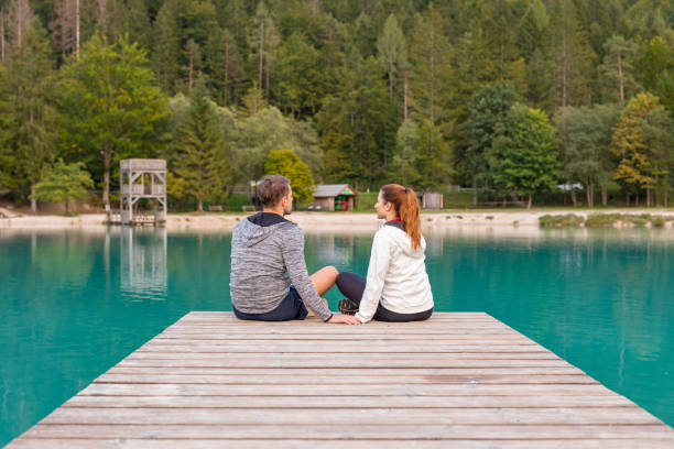 istock Romantic Couple Sitting on a Jetty at a Mountain Lake 1206977463