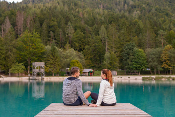 istock Romantic Couple Sitting on a Jetty at a Mountain Lake 1206978301
