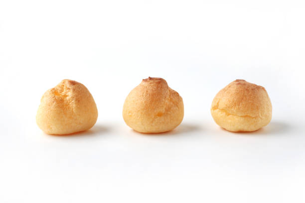 istock cream puffs aligned closeup isolated on white background 1206978942