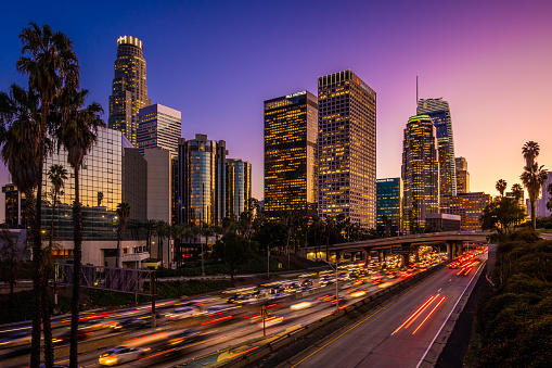 Busy traffic in Downtown Los Angeles at dusk.