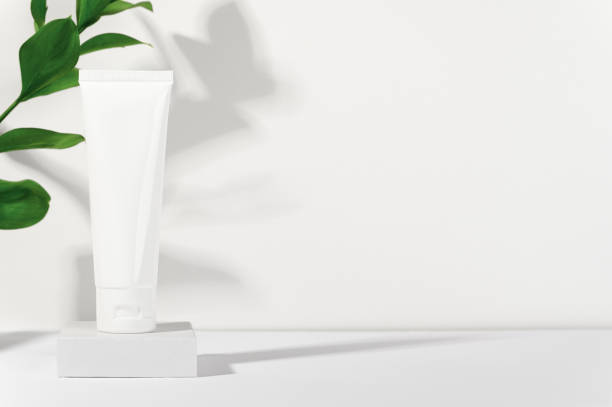 istock White cosmetic products tube on stand. Blank plastic container for cream, lotion, toothpaste, nourishing or moisturizing mask. Eco-friendly, organic cosmetology concept. Copy space in right side 1206979006