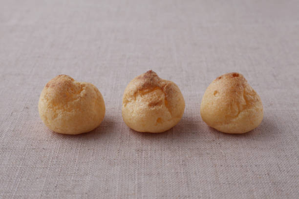 istock cream puffs closeup isolated on table cloth 1206979160