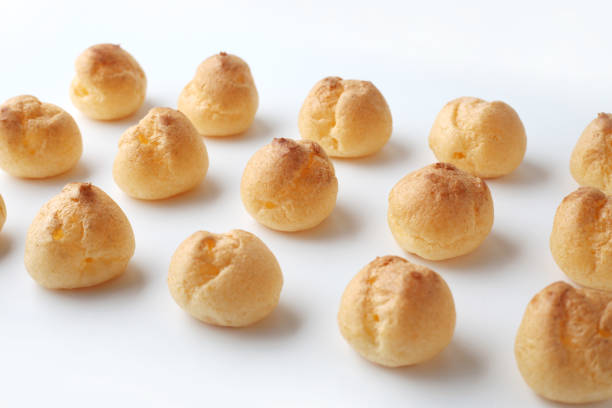 istock cream puffs aligned closeup isolated on white background 1206979896