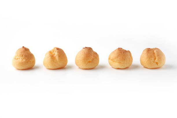 istock cream puffs aligned closeup isolated on white background 1206979919