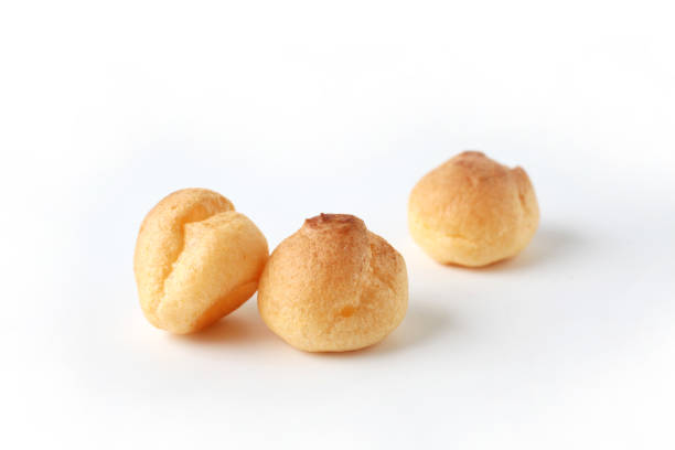 istock cream puffs closeup isolated on white background 1206979942