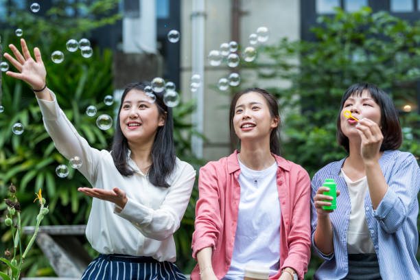 istock Three young girls in the park 1206980096