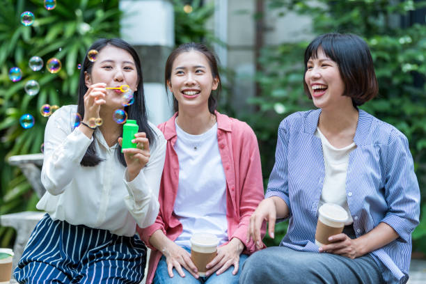 istock Three young girls in the park 1206980107