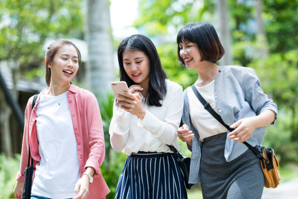 istock Three young girls in the park 1206980124