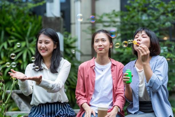 istock Three young girls in the park 1206980143