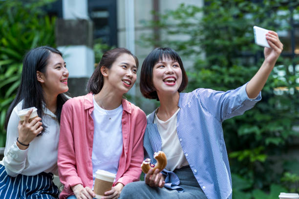 istock Three young girls in the park 1206980145