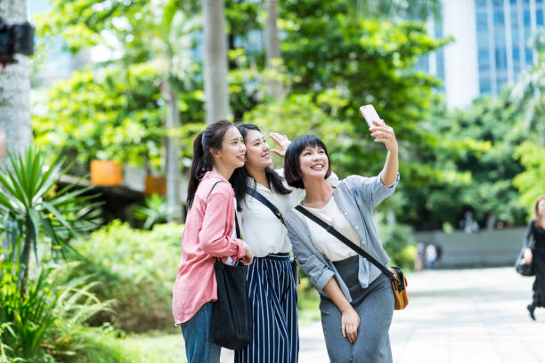 istock Three young girls in the park 1206980152