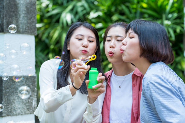 istock Three young girls in the park 1206980162