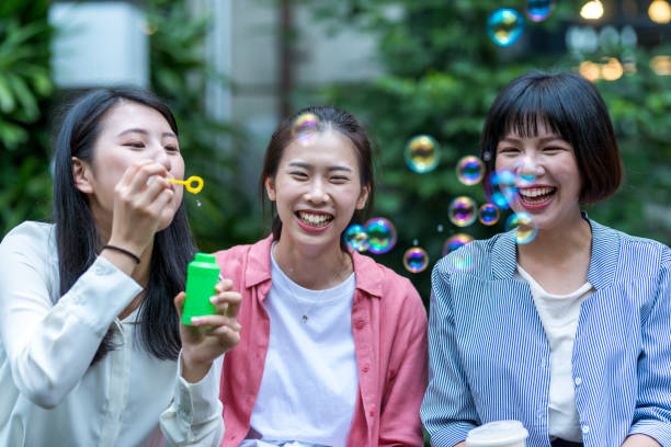 istock Three young girls in the park 1206980164