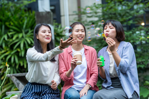 istock Three young girls in the park 1206980167