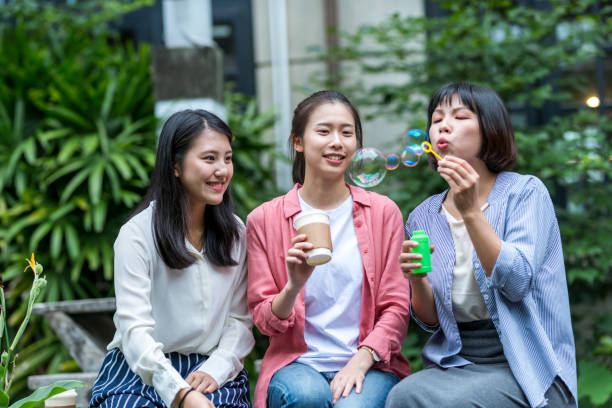 istock Three young girls in the park 1206980185