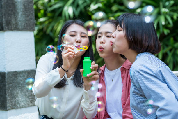 istock Three young girls in the park 1206980188