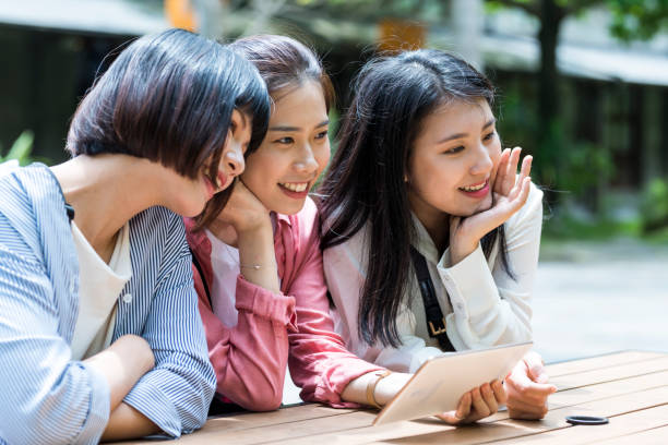 istock Three young girls in the park 1206980201