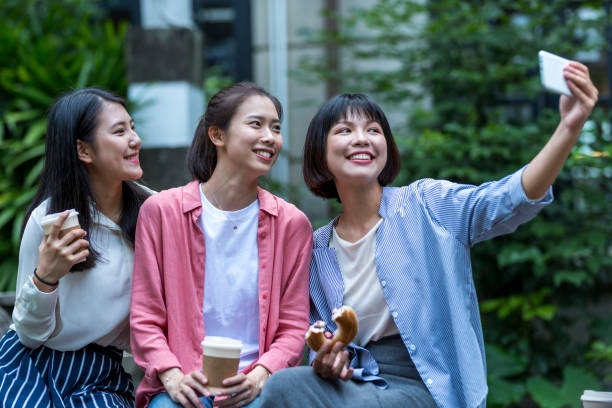 istock Three young girls in the park 1206980202