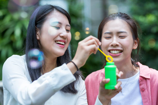 istock Three young girls in the park 1206980209