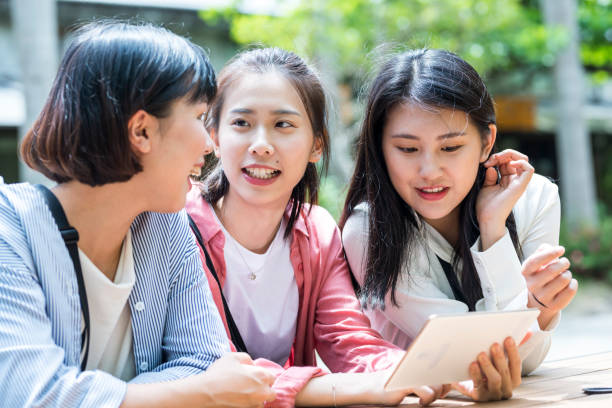 istock Three young girls in the park 1206980222