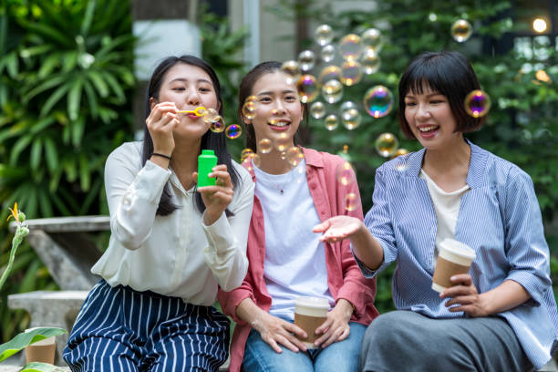istock Three young girls in the park 1206980736